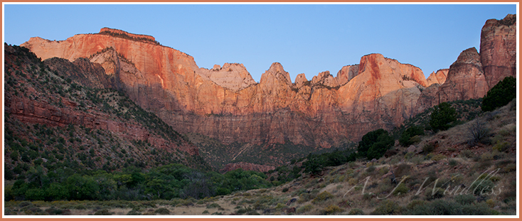 The first light of sunrise creeps down the wall below the Altar of Sacrifice and the West Temple.