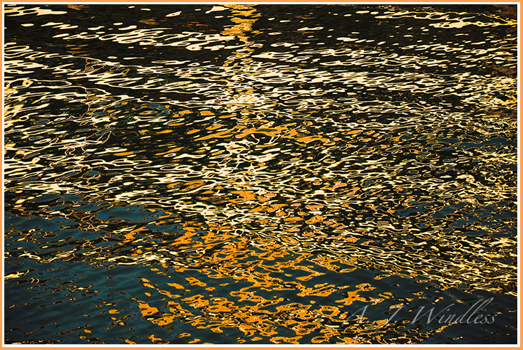 Reflections on the waves appear an eloquent abstract paining.