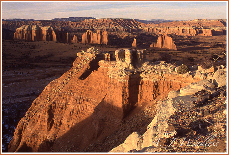 Monoliths rise out of a dramatic sunset landscape.