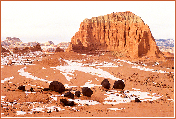 Temple of the Sun fronted by volcanic boulders and a smithering of snow looks like a scene from another planet.